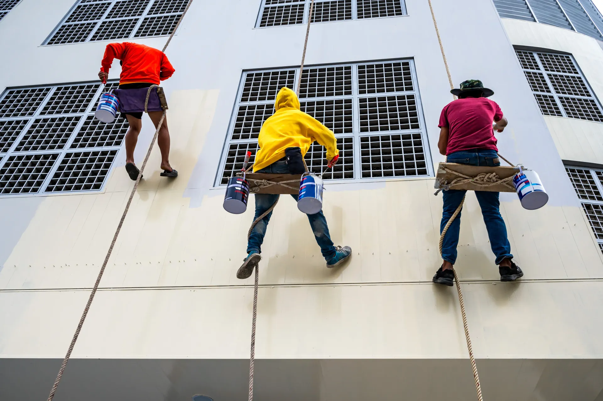 Commercial painters in Rochester, MN painting the side of a building.